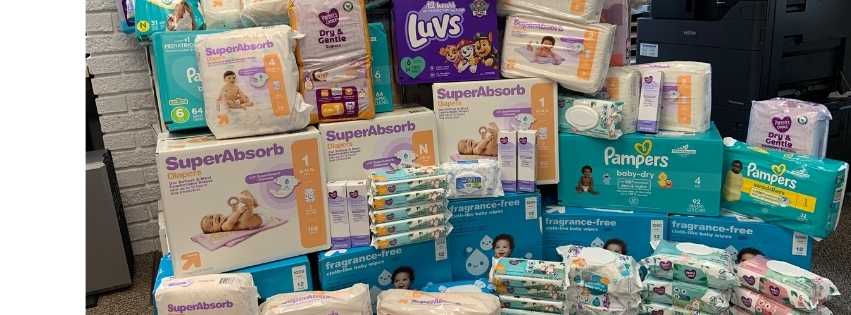 Pile of diapers, wet wipes, and baby cream