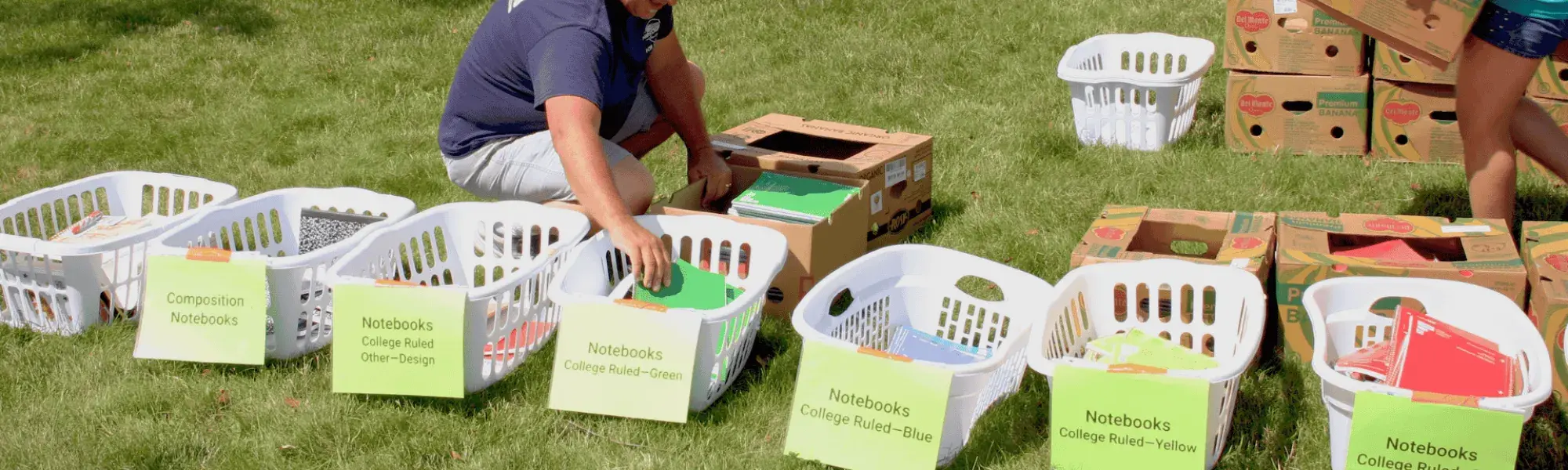 man sorting school supplies by a river